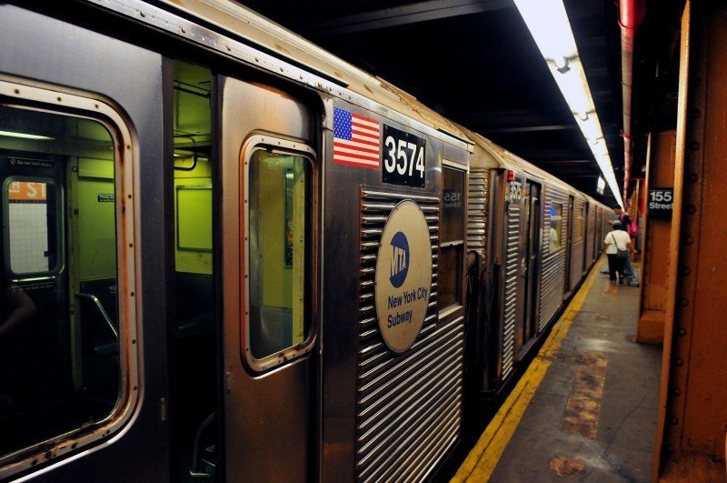 A New York City subway train waiting at a station